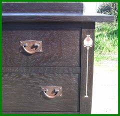 Close-up  hand hammered copper hardware and pewter, copper and curly maple inlay.